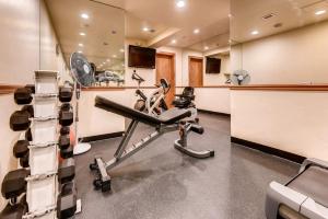 a room with a gym with a bench and equipment at Sitzmark Vail in Vail