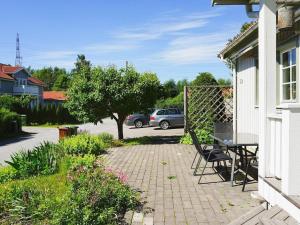 a patio with a table and chairs on a house at 9 person holiday home in SOLLENTUNA in Sollentuna