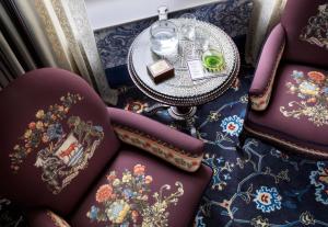 a table and chairs with a tray of food on top at The Randolph Hotel Oxford, a Graduate by Hilton Hotel in Oxford