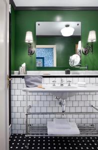 a bathroom with a sink and a mirror at The Randolph Hotel, by Graduate Hotels in Oxford