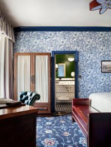 a bedroom with a bed and a desk in a room at The Randolph Hotel Oxford, a Graduate by Hilton Hotel in Oxford