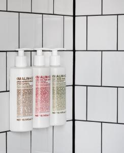 a group of three white bottles on a white tiled wall at The Randolph Hotel Oxford, a Graduate by Hilton Hotel in Oxford
