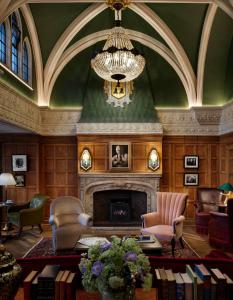 
a living room filled with furniture and a fireplace at The Randolph Hotel, by Graduate Hotels in Oxford

