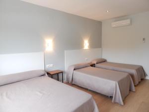 Postel nebo postele na pokoji v ubytování Hostal Las Cumbres