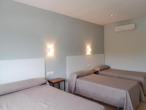 Postel nebo postele na pokoji v ubytování Hostal Las Cumbres