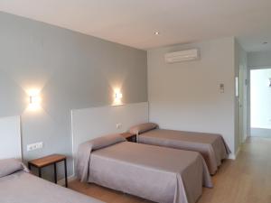 Postel nebo postele na pokoji v ubytování Hostal Las Cumbres