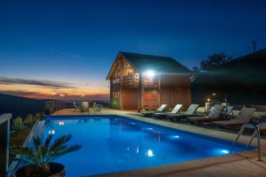 a large pool in front of a house at night at Katune 2020 in Kruta