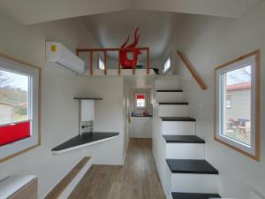 a tiny house with stairs and a bathroom at MY LITTLE TINY HOUSE in Visselhövede