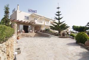 a house with a stone patio in front of it at Sunset Studios in Nea Stira