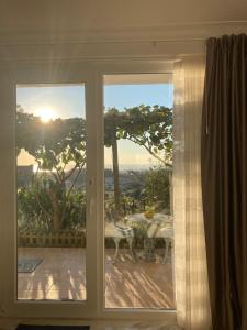 eine Glasschiebetür mit Blick auf eine Terrasse in der Unterkunft Alfazema Sunset House in Vila Nova de Gaia