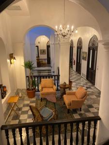 352 Guest House Hotel Boutique في سان خوان: غرفة معيشة فيها كراسي وثريا