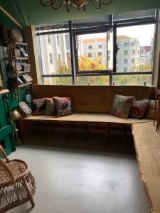 a living room filled with furniture and a window at Hostel Market in Porto