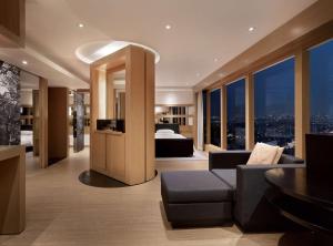 a living room with a couch and a bed in a building at Grand Hyatt Seoul in Seoul