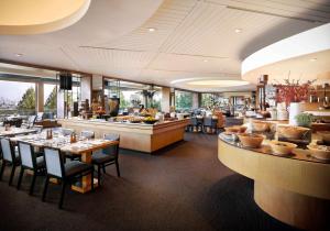 a restaurant with tables and chairs and a bar at Grand Hyatt Seoul in Seoul