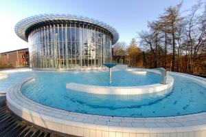 a swimming pool with a large blue fountain at Radisson BLU Palace Hotel in Spa