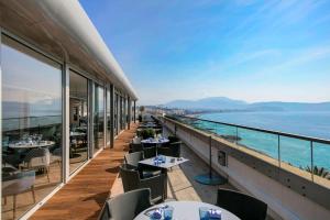 a restaurant with a view of the ocean at Radisson Blu Hotel Nice in Nice
