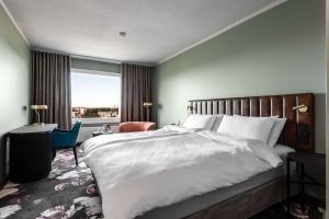 a bedroom with a large bed and a large window at Radisson Blu Hotel, Oulu in Oulu