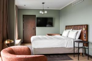 a bedroom with a bed and a chair at Radisson Blu Hotel, Oulu in Oulu