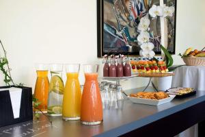 a table topped with vases filled with orange juice at Radisson Blu Paris-Boulogne in Boulogne-Billancourt