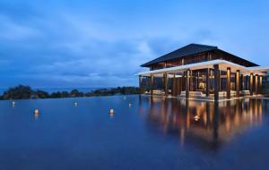 a building with a large body of water at Radisson Blu Bali Uluwatu in Uluwatu
