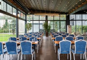 a row of tables and chairs in a room with windows at Radisson Blu Hotel Istanbul Asia in Istanbul +144 photos