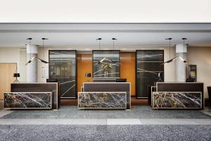 a lobby of a hotel with marble reception desks at Radisson Blu Hotel Hannover in Hannover