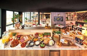 a buffet table filled with lots of different types of food at Radisson Hotel Zurich Airport in Rümlang