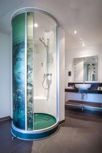 a bathroom with a tub and a shower stall at Radisson Hotel Zurich Airport in Rümlang