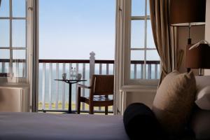 a hotel room with a bed and a view of the ocean at The Marine in Whitstable