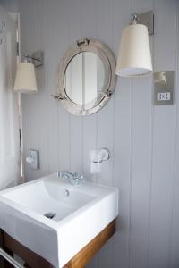 a bathroom with a white sink and a mirror at The Marine in Whitstable