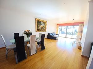 a living room with a dining room table and chairs at Villa Luz - Family House Vacations- Large Private Outdoor Area in Santa Cruz