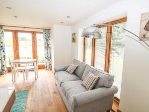 a living room with a couch and a table at Pond View in Norton