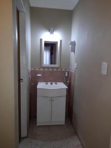 a bathroom with a white sink and a mirror at Guardalaola Patagonia Puelche in Las Grutas