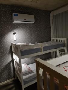 a bedroom with two bunk beds and a ceiling at Dpto The View, Puerto del Águila Lago Los Molinos in Potrero de Garay +17 photos