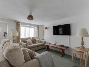 a living room with a couch and a table at Tavern Way in Corfe Castle