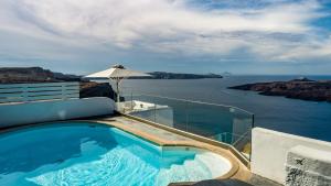 a swimming pool with a view of the ocean at NEOKLASSIKO KOUKOULI in Fira