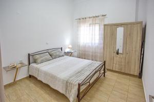 A bed or beds in a room at HAROULENA