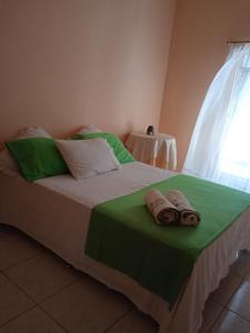 Un pat sau paturi într-o cameră la Pousada Paraíso da Serra