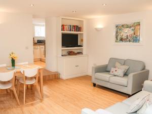 a living room with a couch and a table at 32A, Buxton in Buxton