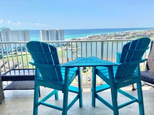 two chairs and a table on a balcony with the ocean at 122 Seascape Dr Unit 1406 in Destin