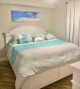 een wit bed met blauwe en witte kussens erop bij 122 Seascape Dr Unit 1406 in Destin