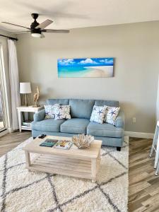 a living room with a blue couch and a coffee table at 122 Seascape Dr Unit 1406 in Destin