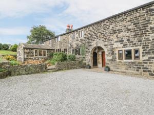 a large stone building with a stone driveway at The Long View in Hebden Bridge