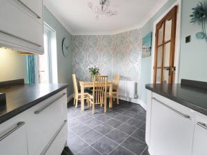 a kitchen and dining room with a table and chairs at Sands End Cottage in Redcar