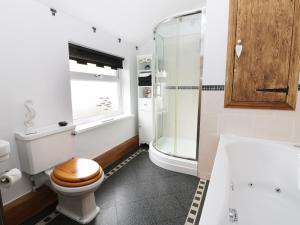 a bathroom with a toilet and a glass shower at Sands End Cottage in Redcar +11 photos