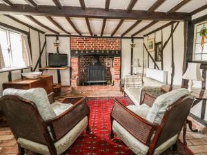 a living room with chairs and a fireplace at Clay Street in Eye