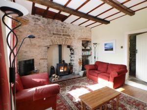 a living room with two red couches and a fireplace at Fellside in Richmond