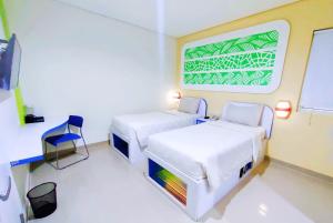 Postel nebo postele na pokoji v ubytování Cordex Hotel Ancol