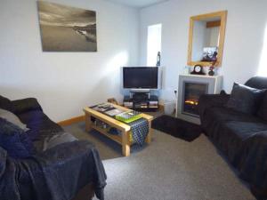 a living room with a couch and a coffee table at Fortunatus in Whitby