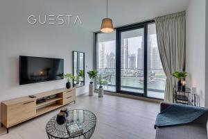 a living room with a tv and a large window at LIV Residence, Dubai Marina in Dubai